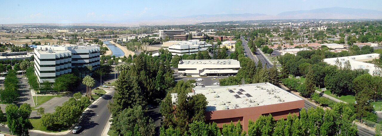 Panorama of Bakersfield, California with the Kern River channel and mountains in the distance