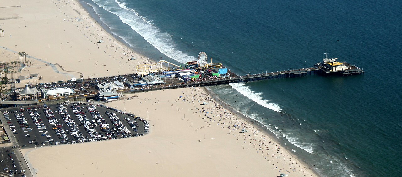 Aerial view of the Santa Monica Pier extending over the Pacific Ocean beside the beach, Santa Monica, California