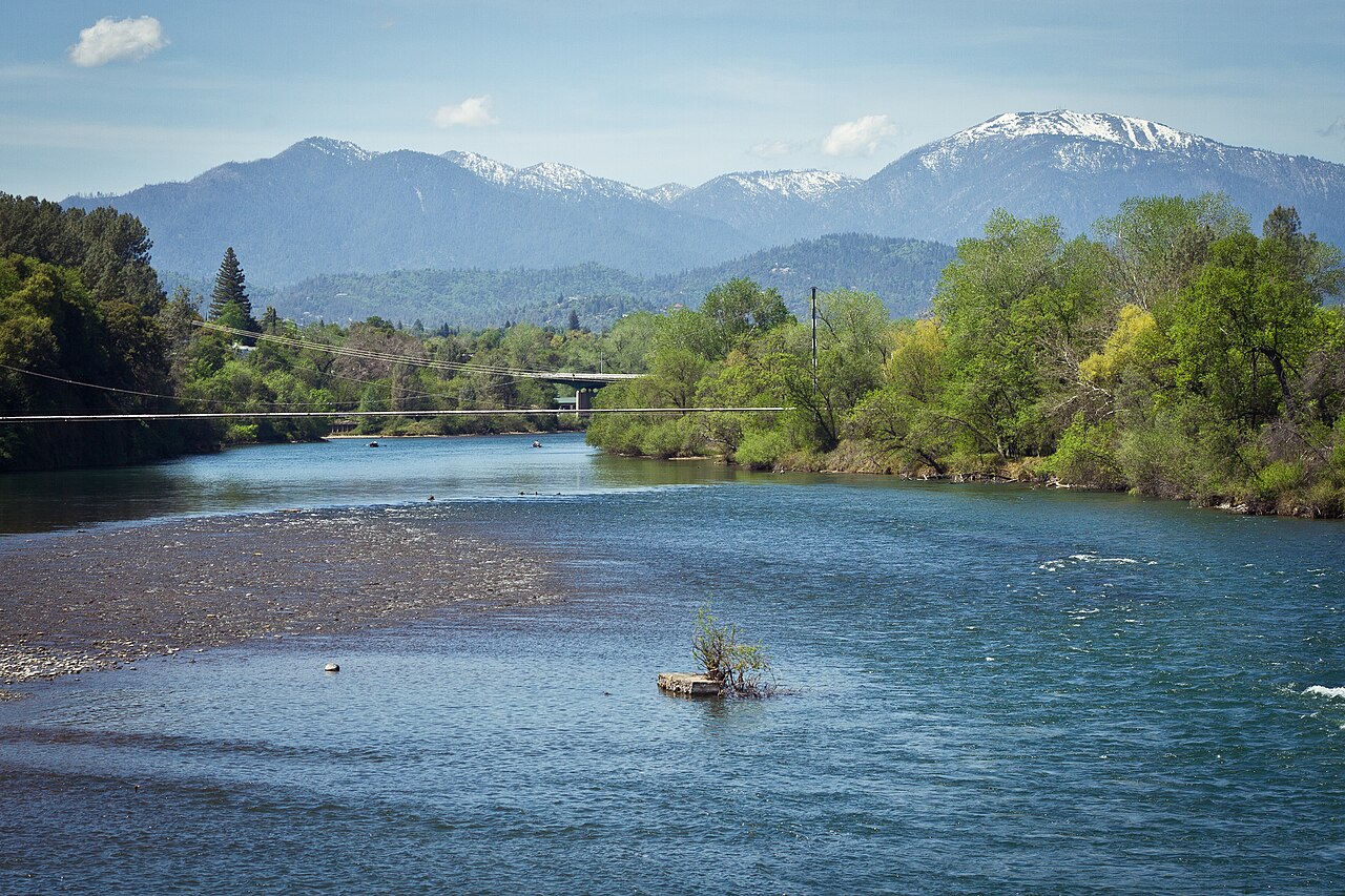River in Redding, California with snow-capped mountains in the distance