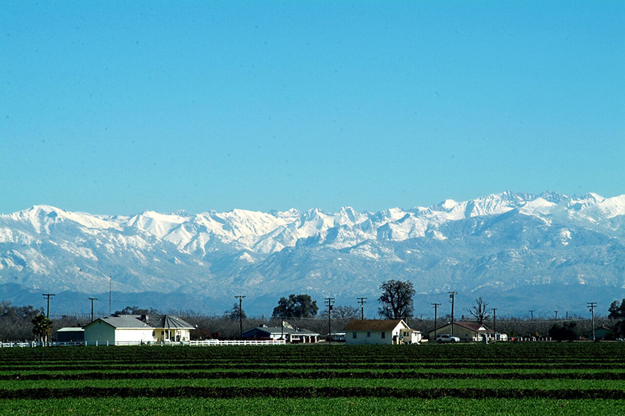 Snow-capped Sierra Nevada seen across farmland near Tulare, Tulare County, California
