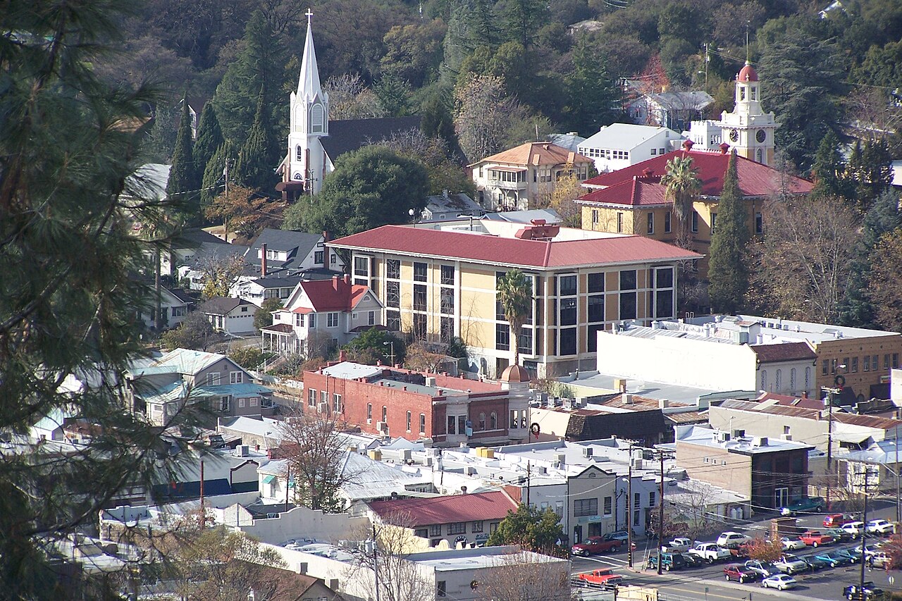 View over downtown Sonora, California, with church steeples and Gold Country hills behind