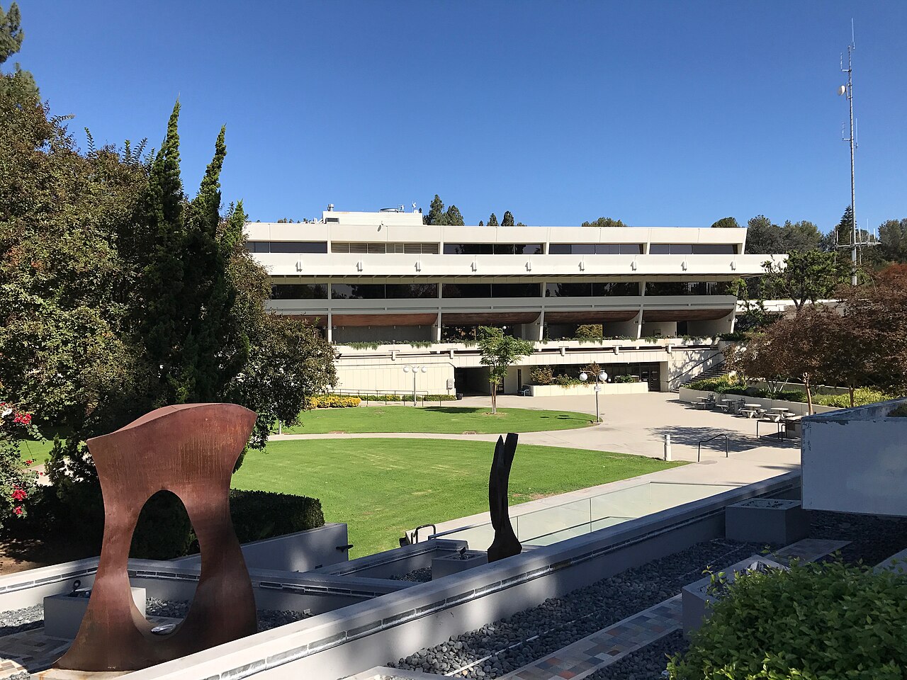 West Covina Civic Center building with lawn and sculpture under a blue sky, West Covina, California