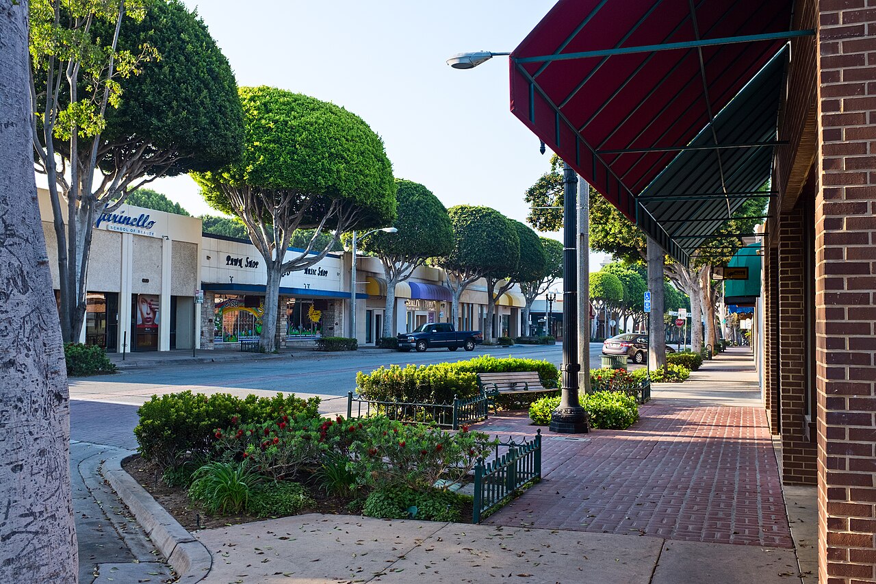 Greenleaf Avenue in Uptown Whittier, California, with trees and shops along the street